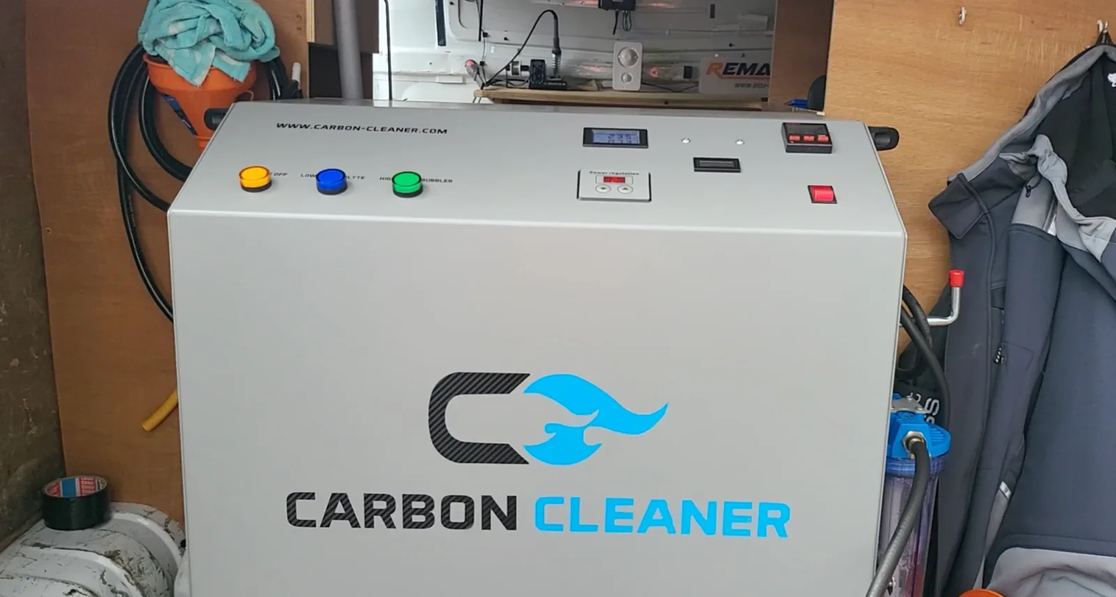 The hydrogen Carbon Cleaner machine in the back of the Remap2Race van, control panel lit and ready to run