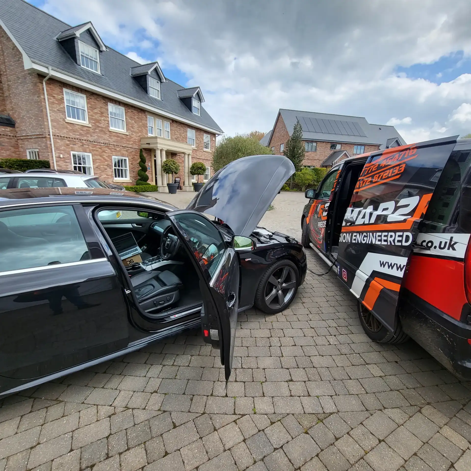 Audi A4 being remapped on an Exeter driveway, Remap2Race van alongside