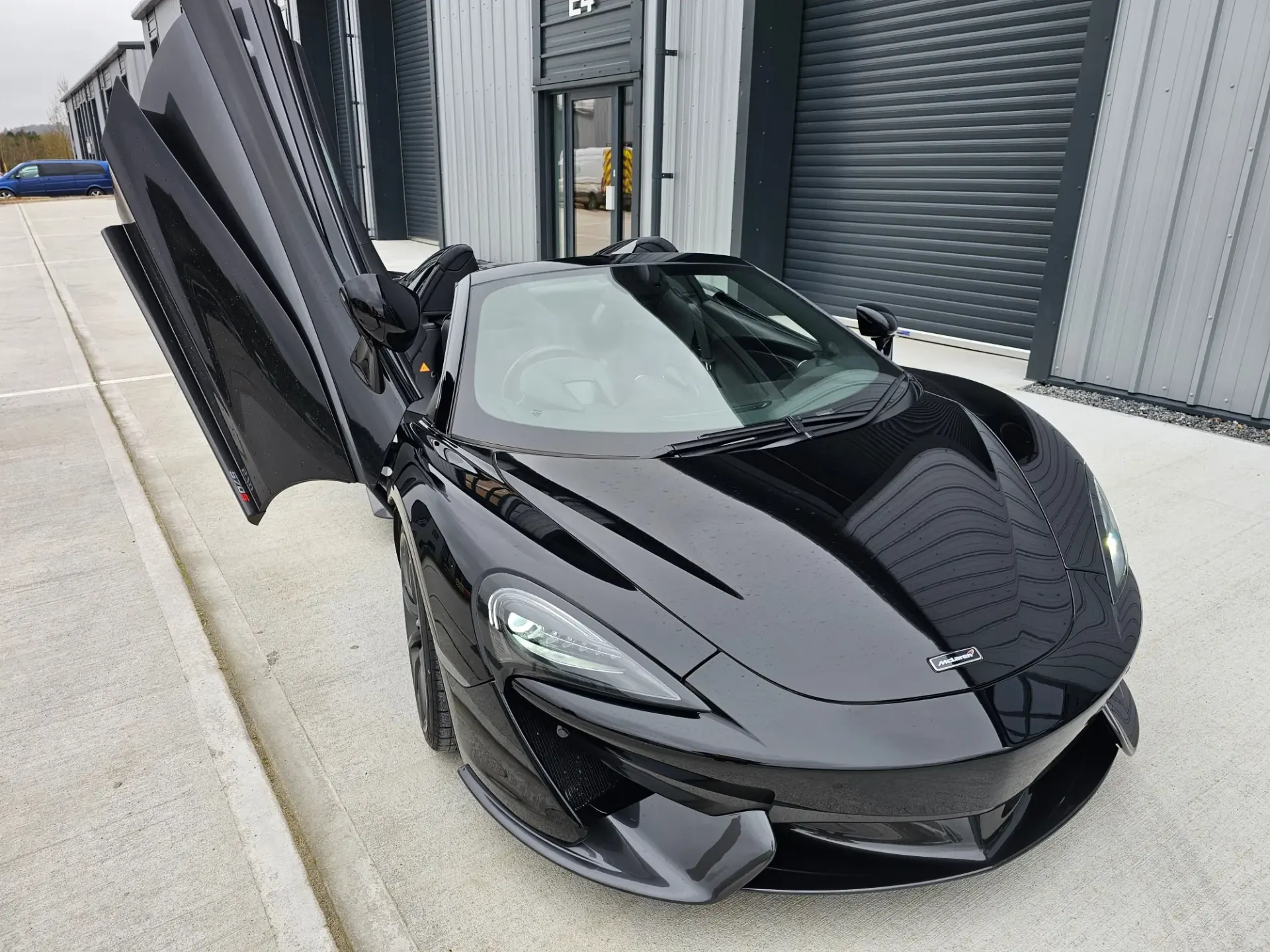 Black McLaren 570S Spider, door up, remapped by Remap2Race using Alientech, Autotuner and CMD Flash professional tooling